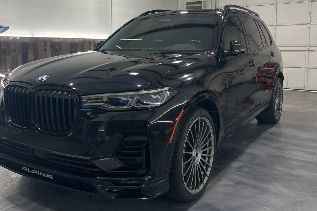 Black Mercedes AMG SUV inside detailing shop.